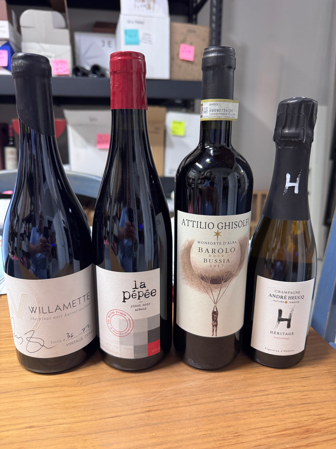 A past Munk Mafia Wine Club Mixed bundle with three bottles of red wine and one split of Champagne arranged together.
